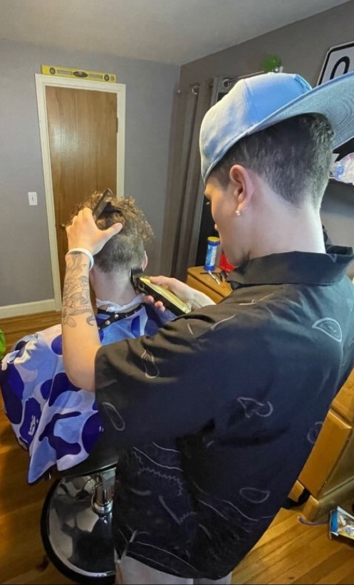 Spencer cutting hair from behind