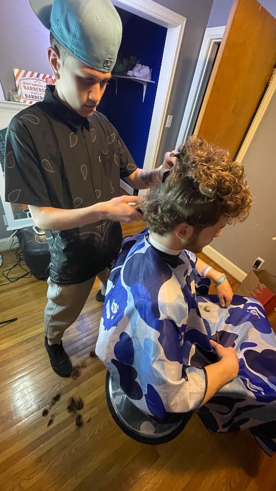 Spencer cutting hair from the front